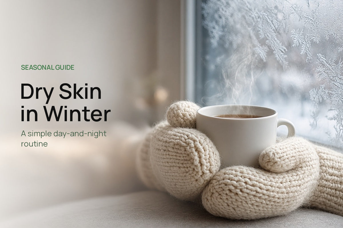 Hands in cream knit mittens holding a steaming mug beside a frosted window, with the title Dry Skin in Winter