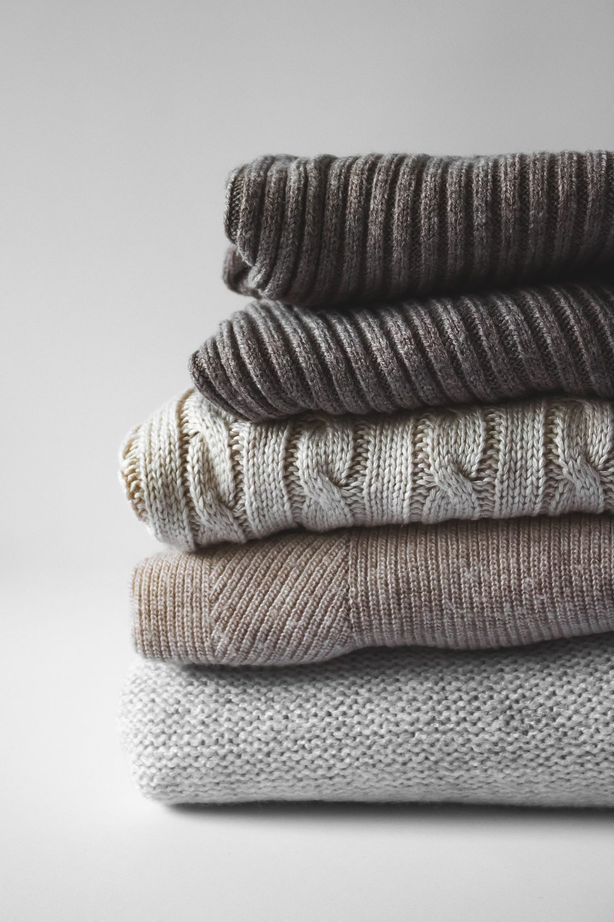 Neat pile of warm knit sweaters
